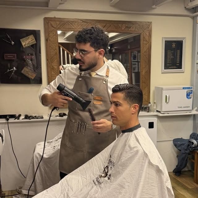 A barber finishing a haircut at The Groomsmith
